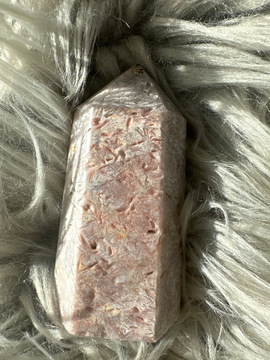 Pink amethyst with rutile tower.