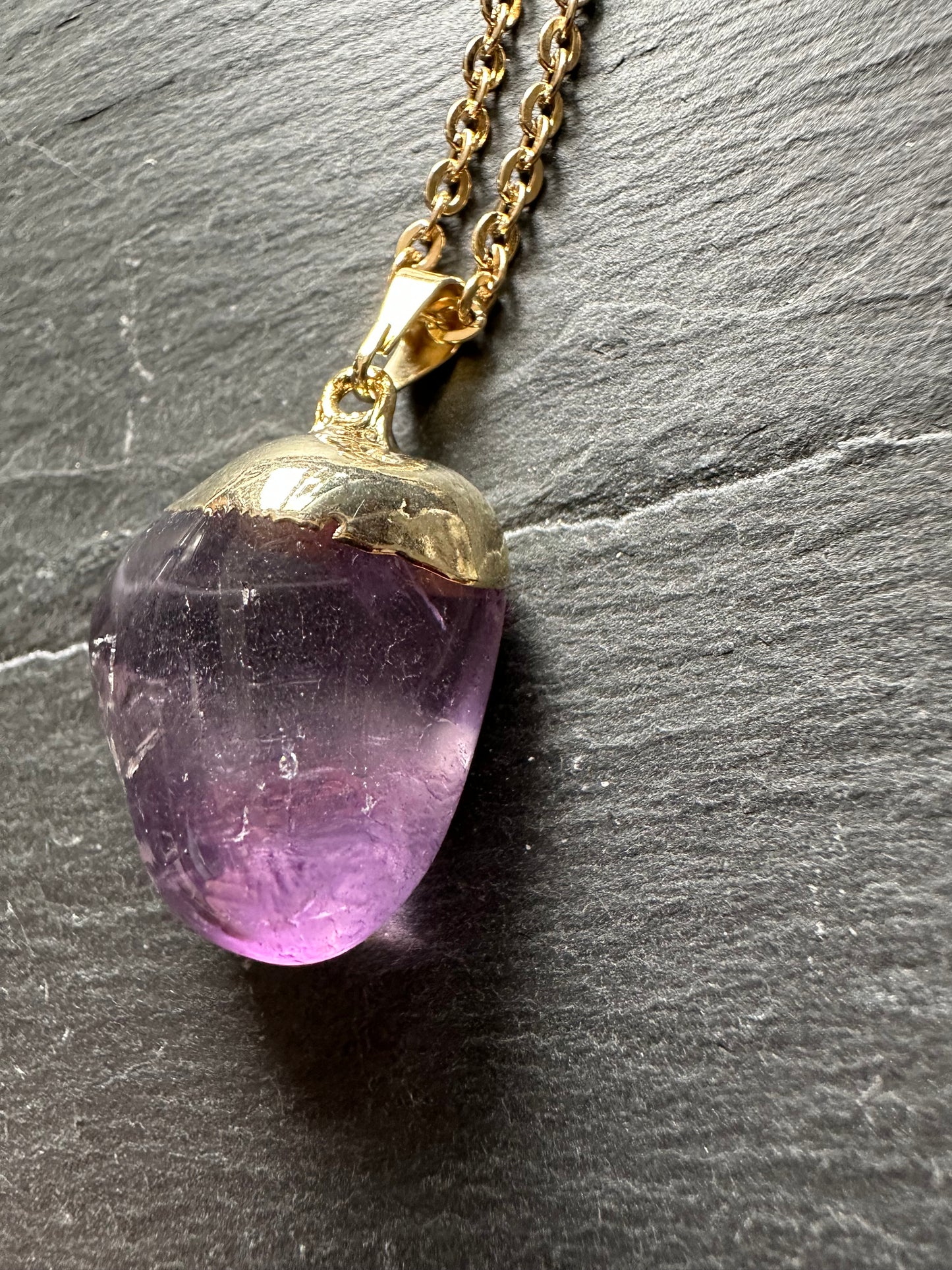 Polished amethyst on chain.